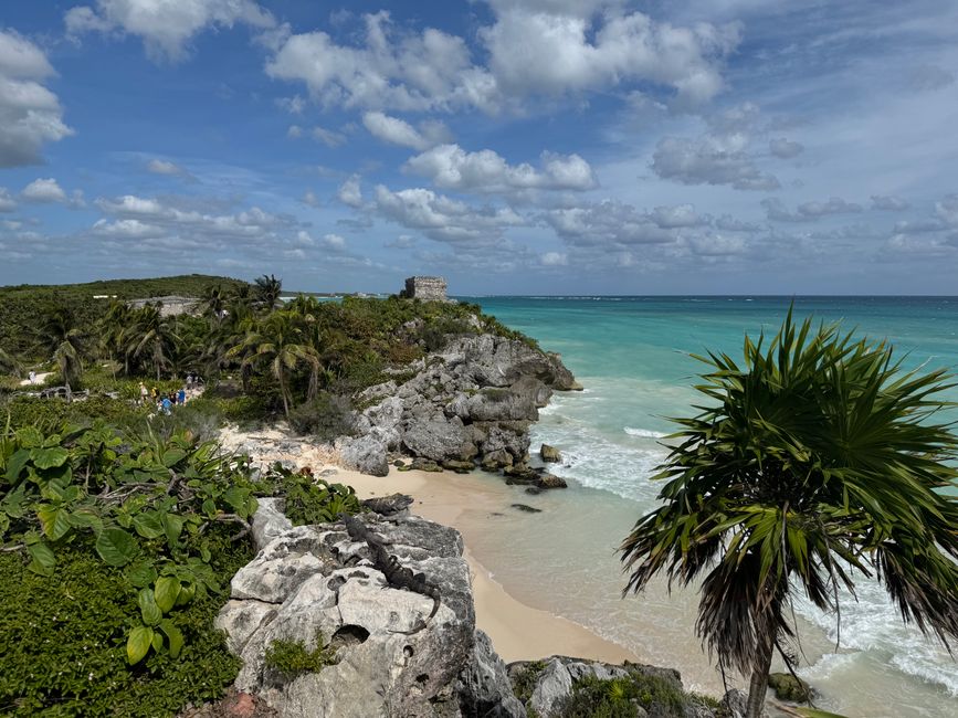 Stunning coastal view of Tulum Ruins with turquoise ocean and lush greenery.