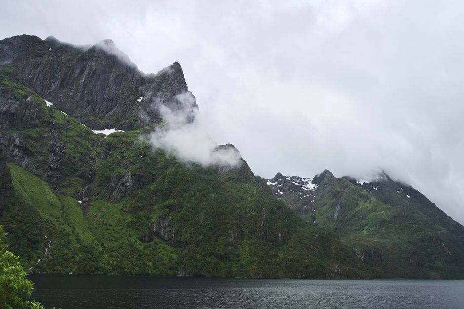Clouds wrapping green mountains in Lofoten