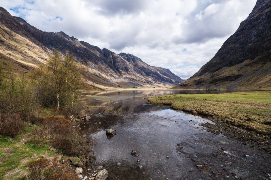 Glencoe Valley mountains and calm river Scotland