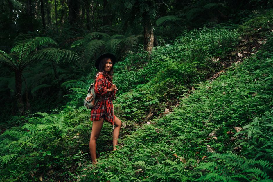 Hiker walking through lush Madeira jungle path