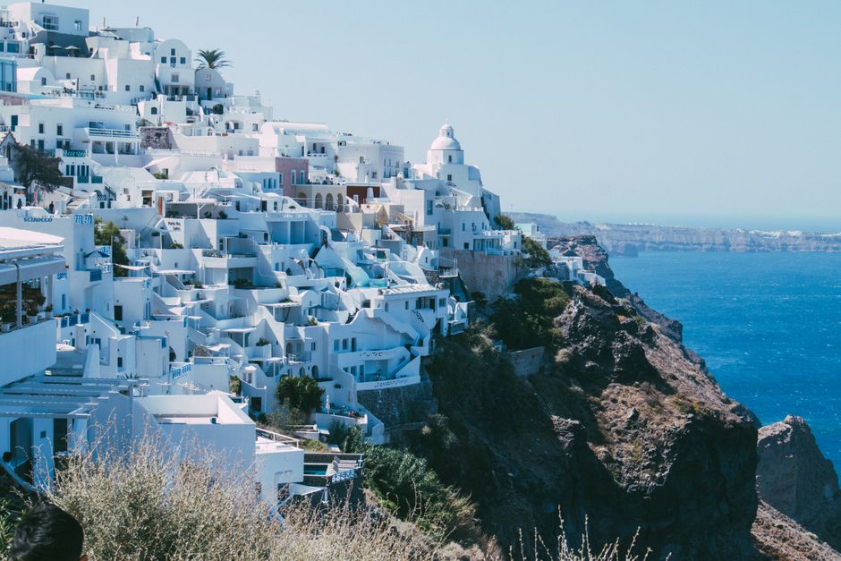 Breathtaking view of Santorini's iconic whitewashed buildings perched on a cliff overlooking the sea.