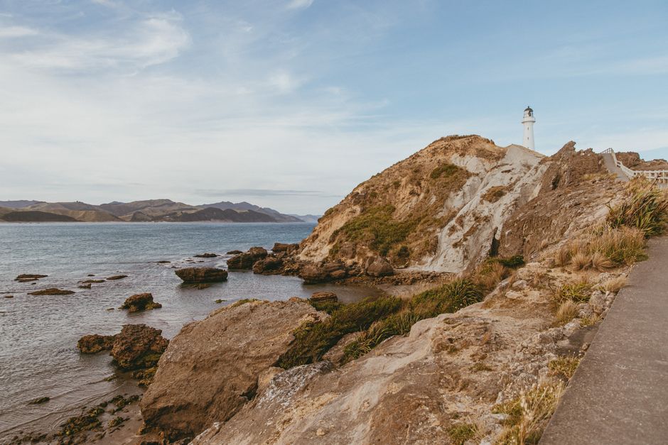 Beautiful view of Castlepoint Lighthouse standing tall on the rugged New Zealand coast.