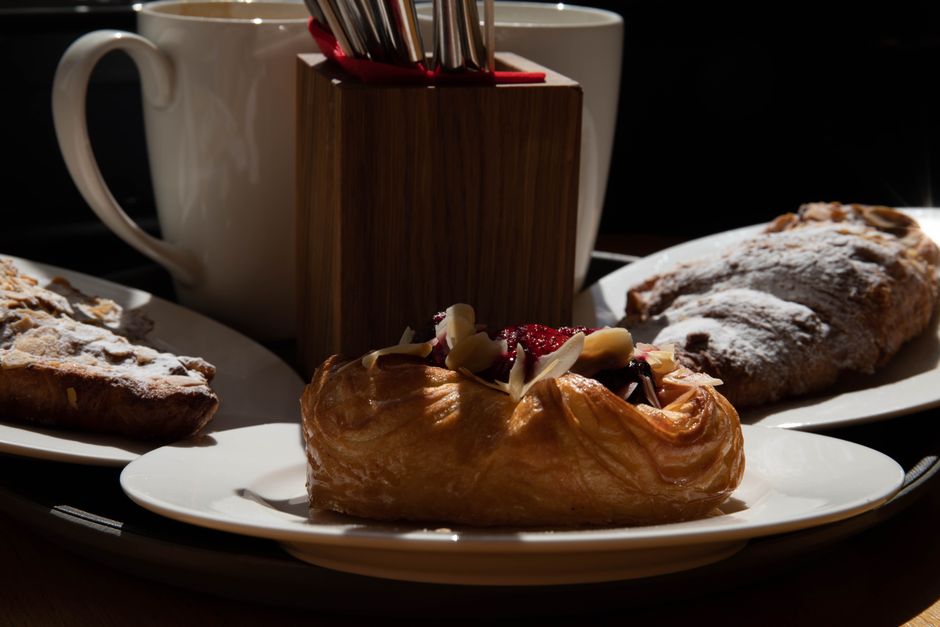 Close-up view of assorted pastries with coffee in a cozy setting.