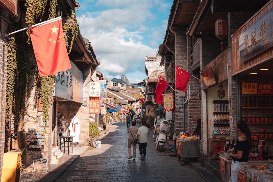 A vibrant street market scene in Xingping, China, showcasing traditional architecture and local shops.