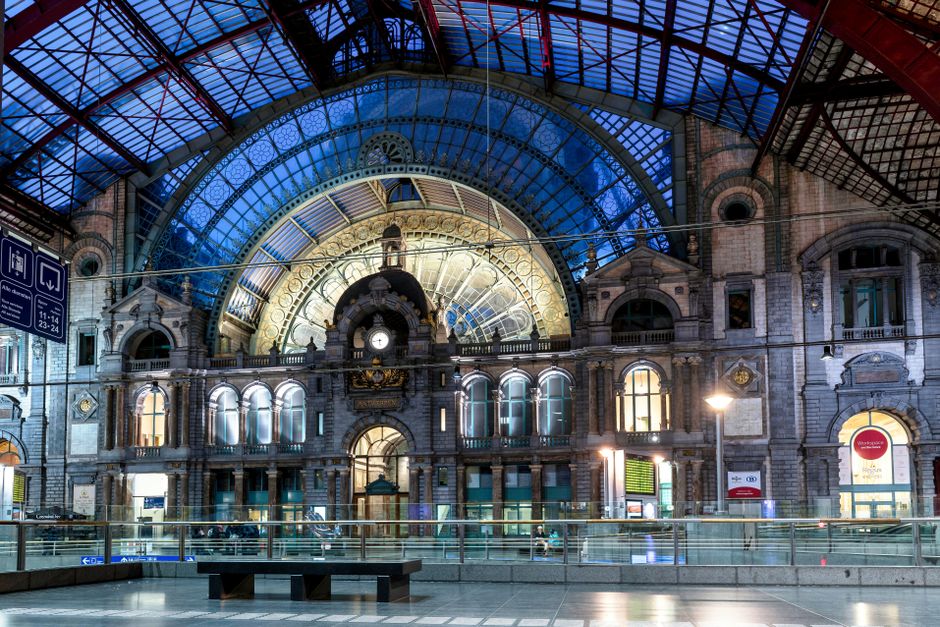 Interior view of Antwerpen Central Station showcasing its iconic architectural facade during dusk.