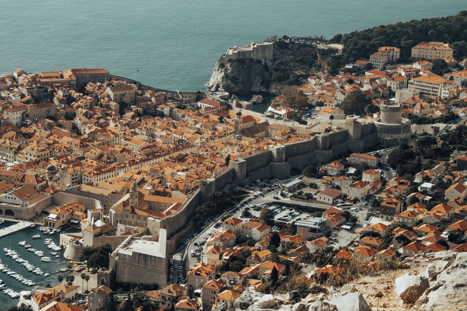 Explore Dubrovnik's historic Old Town from above, showcasing its iconic medieval walls and stunning Adriatic coastline.
